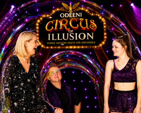 Odeeni Circus of Illusion performers creating a giant bubble during a colourful live stage performance.