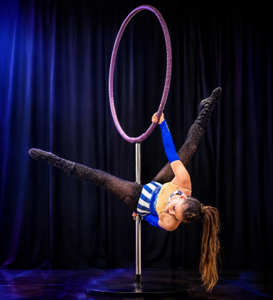 Aerial hoop performer from Odeeni Circus of Illusion performing an acrobatic pose on stage.